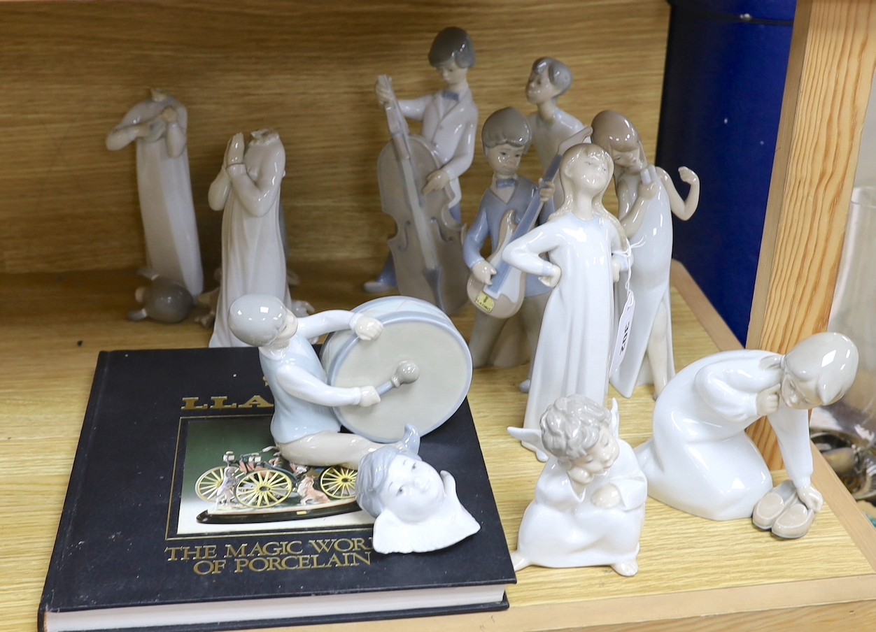 A Lladro collection: seven figures, five further damaged figures and a Lladro reference book